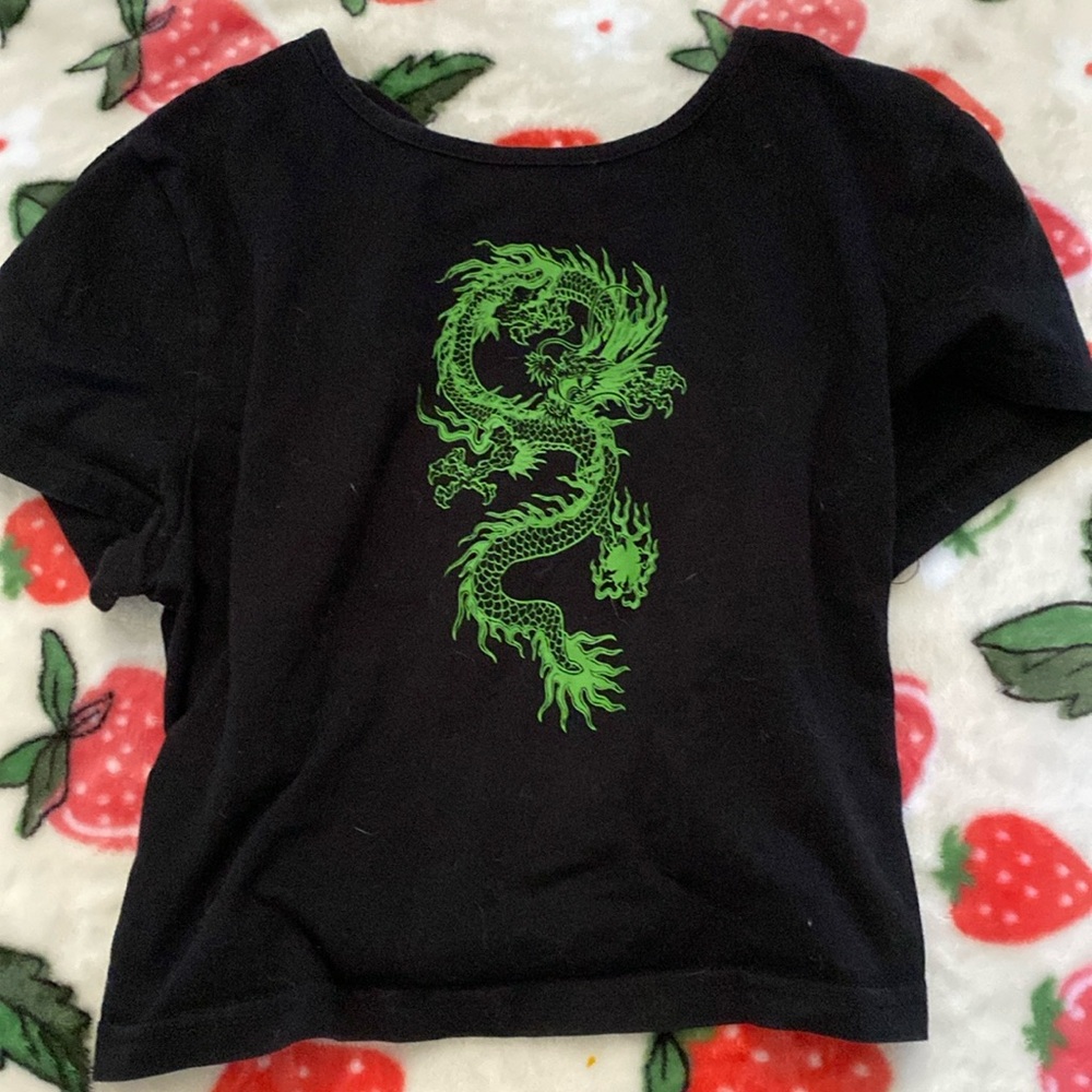 A crop top with a green dragon on it.